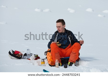 A Skier Takes a Well-Deserved Break to Enjoy the View Royalty-Free Stock Photo #2448703241