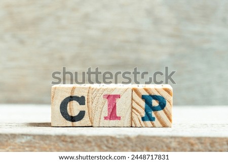 Alphabet letter block in word CIP (Abbreviation of Carriage and Insurance Paid to, Continual improvement process or Clean-in-place) on wood background