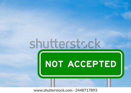 Green color transportation sign with word not accepted on blue sky with white cloud background Royalty-Free Stock Photo #2448717893