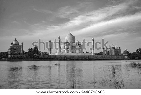 
The Taj Mahal's silhouette gracefully adorns the river's surface, a timeless reflection of architectural grandeur amidst serene waters. Royalty-Free Stock Photo #2448718685