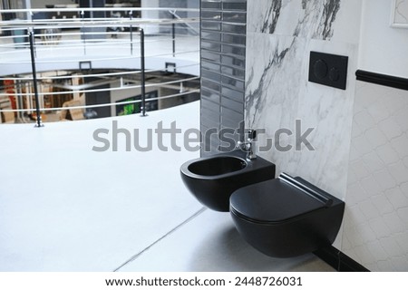Interior photography of plumbing establishment where tiles, bathtubs, furniture and toilets are sold.