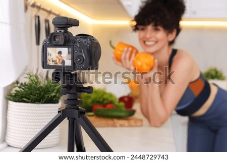 Food blogger explaining something while recording video in kitchen, focus on camera Royalty-Free Stock Photo #2448729743