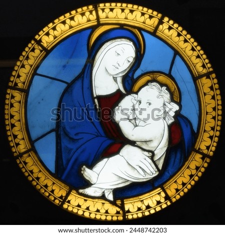 Stained glass window depicting Madonna and Child. Bologna, Italy Royalty-Free Stock Photo #2448742203