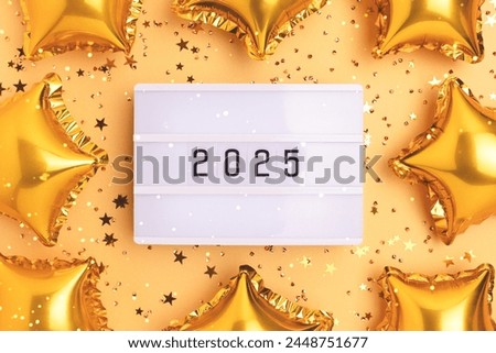 Lightbox with 2024 numbers on a golden background. Frame made of stars confetti and inflatable balloons. New Year composition.