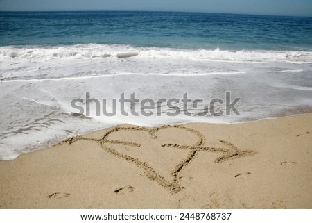 Heart. Heart drawn on sand of a tropical beach at sunset. Clear turquoise ocean. Laguna Beach California. Words written in sand. Happy Valentines Day. Words of Love. Love Symbol. I love you. True Love