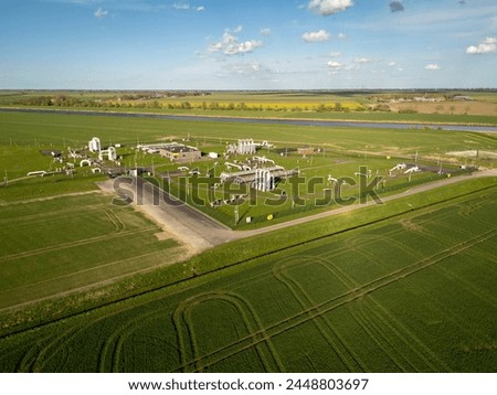 Controversial Gas Field in Groningen: Aerial View of Industrial Pipelines in Farmland Royalty-Free Stock Photo #2448803697