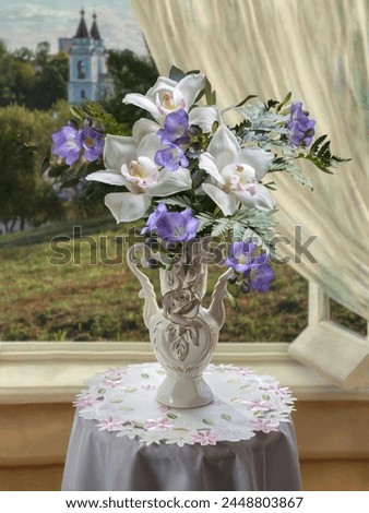 Still life with orchid flowers in vase on table