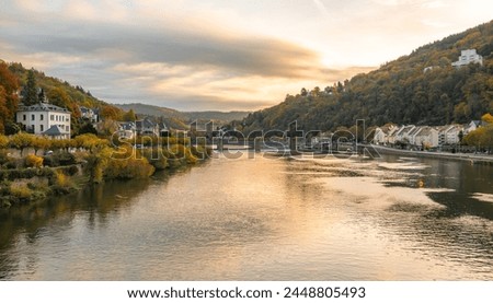 Beautiful morning view with warm colors on the riverbanks of the Neckar river. Beautiful historical city of Heidelberg in Germany. Beautiful touristic spot. Must-see spot in Germany. Wonderful view in Royalty-Free Stock Photo #2448805493
