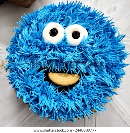 blue color smiling cake, cookie monster cartoon character