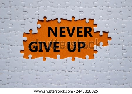 Never give up symbol. Concept words Never give up on white puzzle. Beautiful orange background. Business and Never give up concept. Copy space.