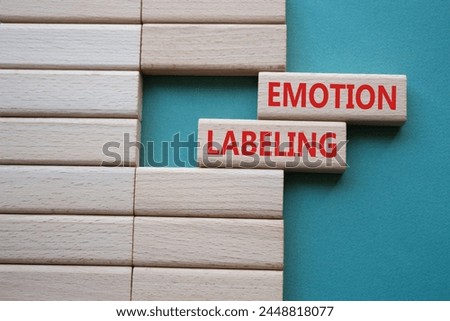 Emotion Labeling symbol. Concept words Emotion Labeling on wooden blocks. Beautiful grey green background. Psychology and Emotion Labeling concept. Copy space.