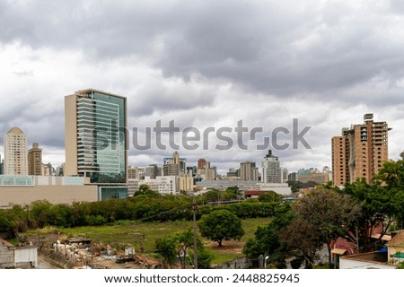 Cloudy sky. Buildings under construction. Several residential and commercial buildings. Horizontal. Space for advertising.
