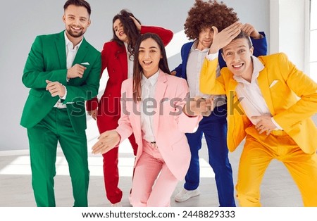 Happy bright group, entertaining people in vibrant vivid formal suit, cool happy, office party gathering. Young cute disco team color suit set wear, express enjoyment, colorful mood, event performance Royalty-Free Stock Photo #2448829333