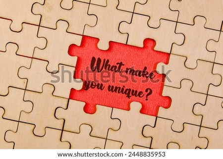 Discover the power of self-discovery with this captivating image featuring puzzle pieces forming the question "What makes you unique?