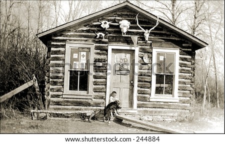 Vintage Photo of a Boy And Dog In Front Of Shack