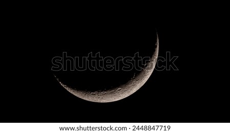 A stunning closeup of a crescent moon in the night sky, capturing the beauty of this celestial event with flash photography