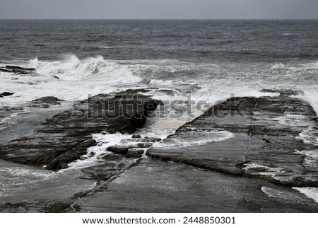 rough coastal waves breaking on rocks