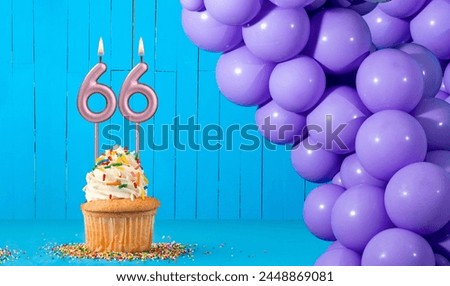 Birthday candle number 66 - Cupcake and balloon decoration Royalty-Free Stock Photo #2448869081