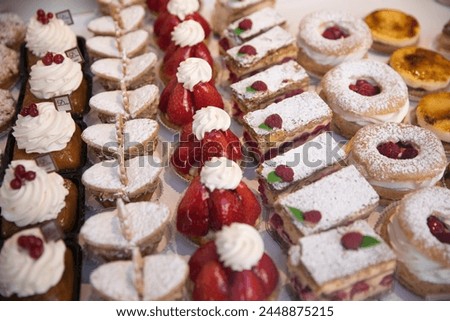 Tasty pastries in window of French patisserie shop, Arras, Pas-de-Calais, Hauts-de-France region, France, Europe Royalty-Free Stock Photo #2448875215