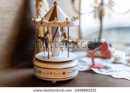 A miniature merry-go-round decoration by the window