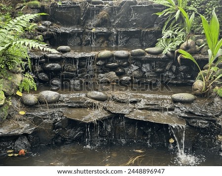 waterfall background with stones and plants