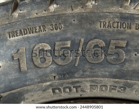 Closeup of text 16565 showing width and aspect ratio of a tyre. Royalty-Free Stock Photo #2448905801