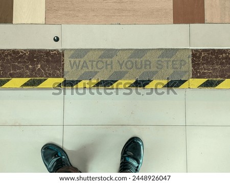 background photo of the floor with the words watch your step