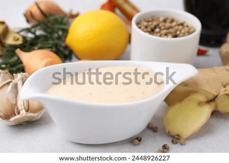 Fresh marinade and different ingredients on light grey table, closeup