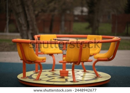 wooden bench in the park Children's carousel