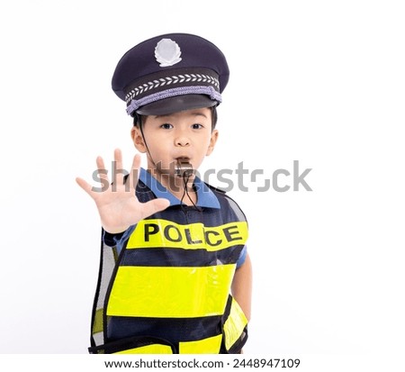 child dressed as a police officer standing and showing stop sign