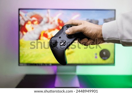 Holding the gamepad in your hand presses the gamepad stick with your finger. Video game gamepad in hand
