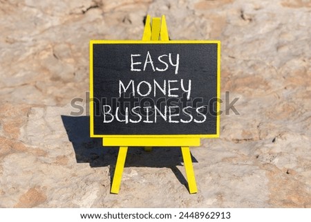 Easy money business symbol. Concept words Easy money business on beautiful black chalk blackboard. Beautiful red stone background. Easy money business concept. Copy space.