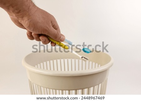 Throw used toothbrushes in the trash. Disposal of toothbrushes. Royalty-Free Stock Photo #2448967469
