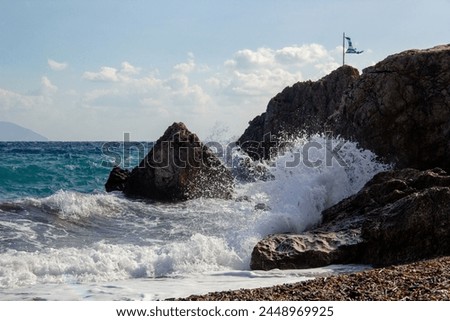 Beautiful landscapes in sunny Greece, on the shore of the blue sea among stones and rocks.