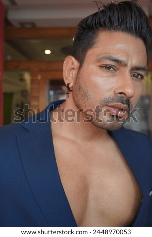 Confident Indian man showcasing his chest, exuding strength and charisma. Ideal for fitness, lifestyle, and masculinity concepts Royalty-Free Stock Photo #2448970053