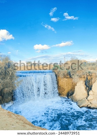 beautiful view of the beautiful combination of blue and brown colors of the waterfall and land in Wadi El Rayan, Egypt