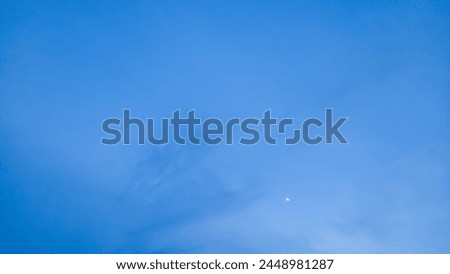 A picture of moon light on blue sky with white cloud as background 
