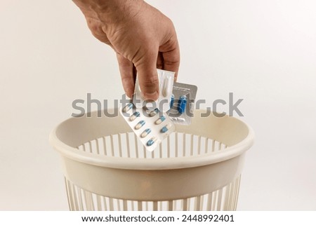 Expired medicines are thrown into the trash. Utilization of medicines. Royalty-Free Stock Photo #2448992401