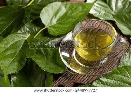 Mulberry Tea. Glass cup of mulberry leaf tea. Royalty-Free Stock Photo #2448999727