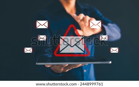 Male hand using tablet with spam email icon Mobile spam links Email icon virus on smartphone virtual screen holographic technology theme. Hacke Royalty-Free Stock Photo #2448999761