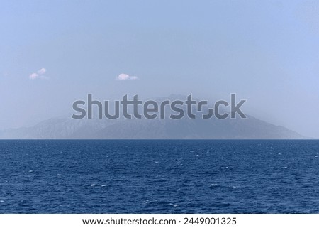 Blue sea and island view on a misty day. Samothrace (Samothraki), one of the Greek islands in the Aegean Sea. Wallpaper backgrounds, seascape and vacations concepts.