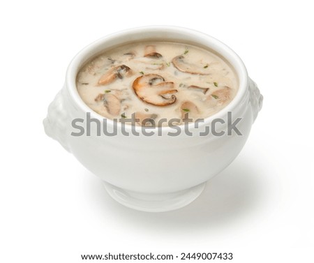 Cream of mushroom soup in a white porcelain tureen isolated on a white background.  Royalty-Free Stock Photo #2449007433