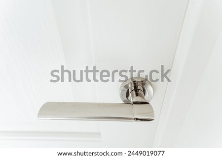 Chrome handle door hardware, matte metal finish. High quality photo Royalty-Free Stock Photo #2449019077