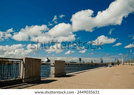Riga, Latvia – May 5, 2023:embankment and promenade for pedestrian walks on the river bank on a clear sunny day.
