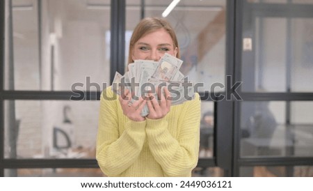 Portrait of Blonde Young Woman Enjoying Money Rain