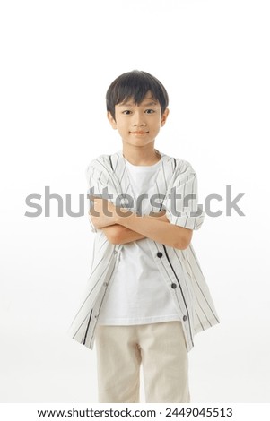 Happy Asian little boy cross arms and confident isolated on white background, Excited kid winner success concept, Looking at camera.