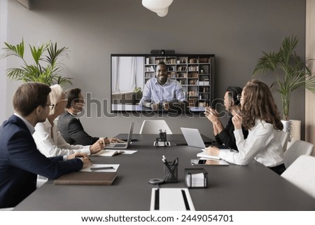 Male applicant pass job interview remotely using video call. Group of HR managers interviewing African candidate through videoconference. Communication using videocall app, virtual business meeting Royalty-Free Stock Photo #2449054701