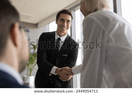 Business partners greeting each other at formal meeting in office. Shake hands as sign of acceptance, making profitable deal, buy or sell company services. Applicant get hired, establish partnership
