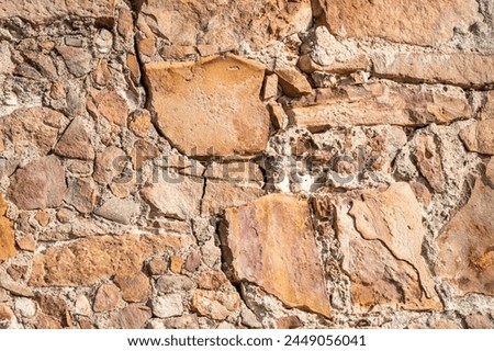 Very old stone wall, perfect for background.
 Barcelona, Catalonia, Spain.