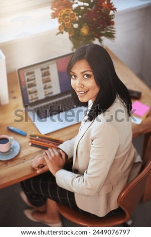 Portrait, woman and laptop screen with smile in home office in company or business for stationary, files and coffee. Female entrepreneur, online and ux in startup for tech, above and workspace